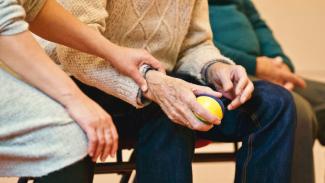 Elderly person holding a stress ball